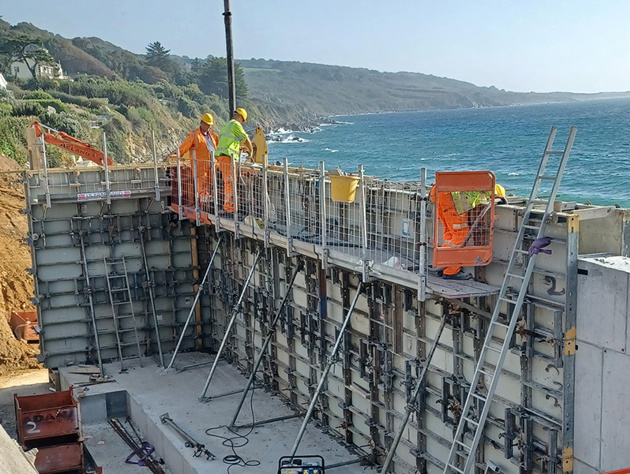 Men Working On Retaining Wall At Height